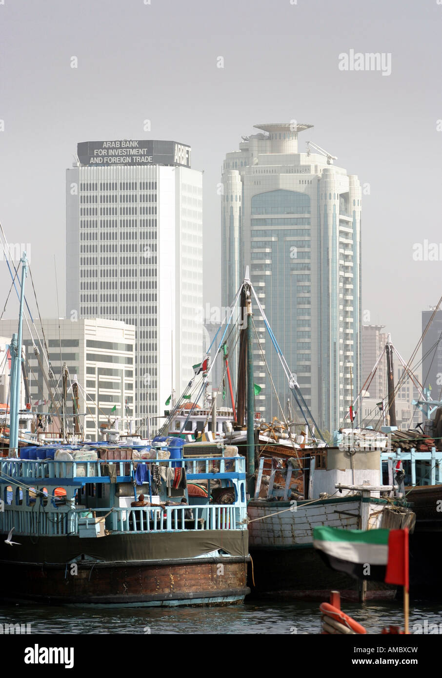 Old dhows in front of modern skyscrapers, Dubai harbour, UAE Stock Photo