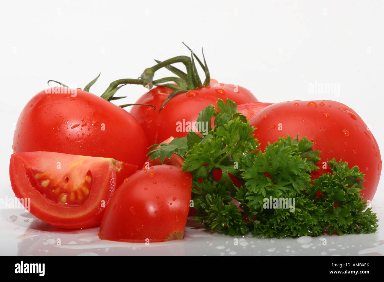 Cross section of organic red tomatoes whole and sliced studio image on ...
