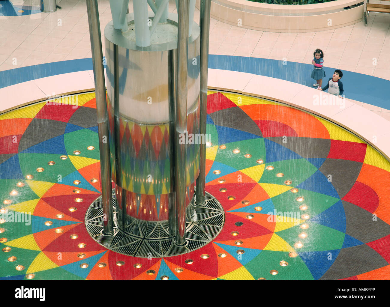 Two children gaze at the fountain, Marina Mall, Abu Dhabi city UAE Stock Photo