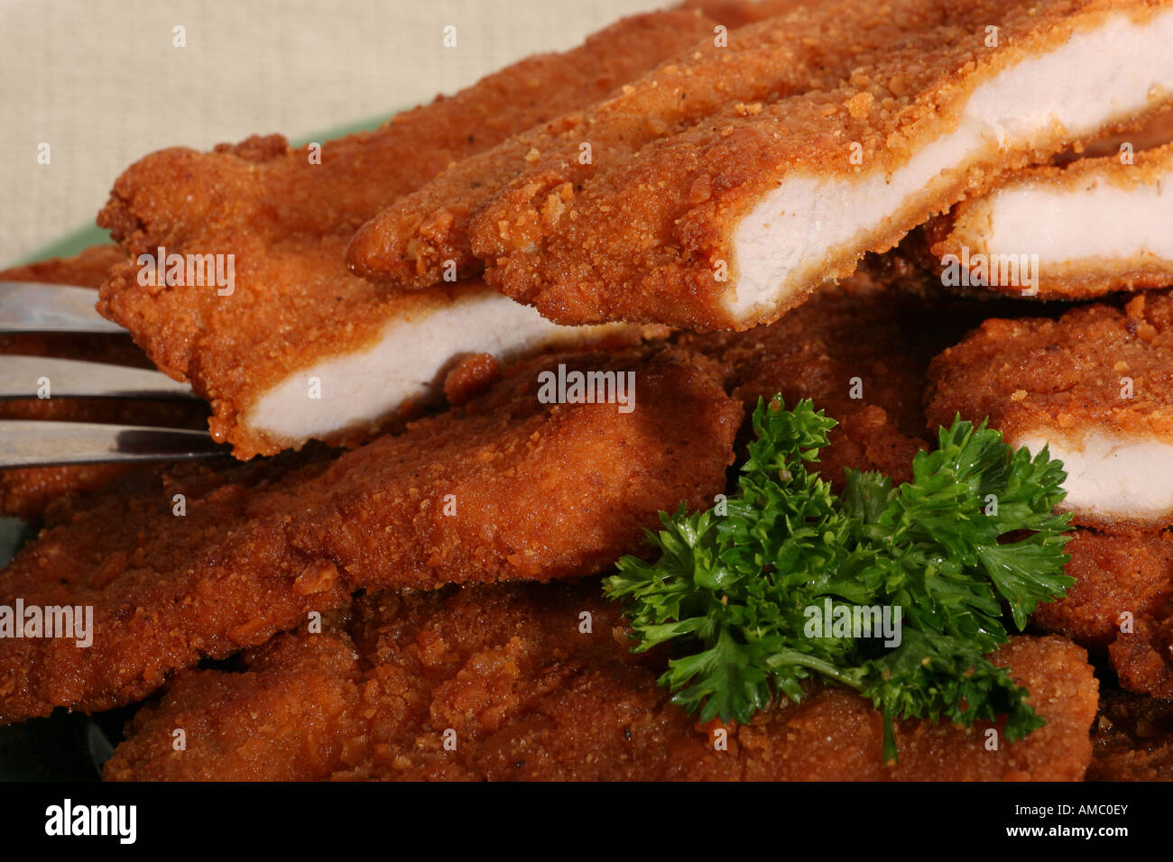 Breaded fried pork chops chop on a plate several cutlets and vegetables food nobody overhead  closeup horizontal hi-res Stock Photo