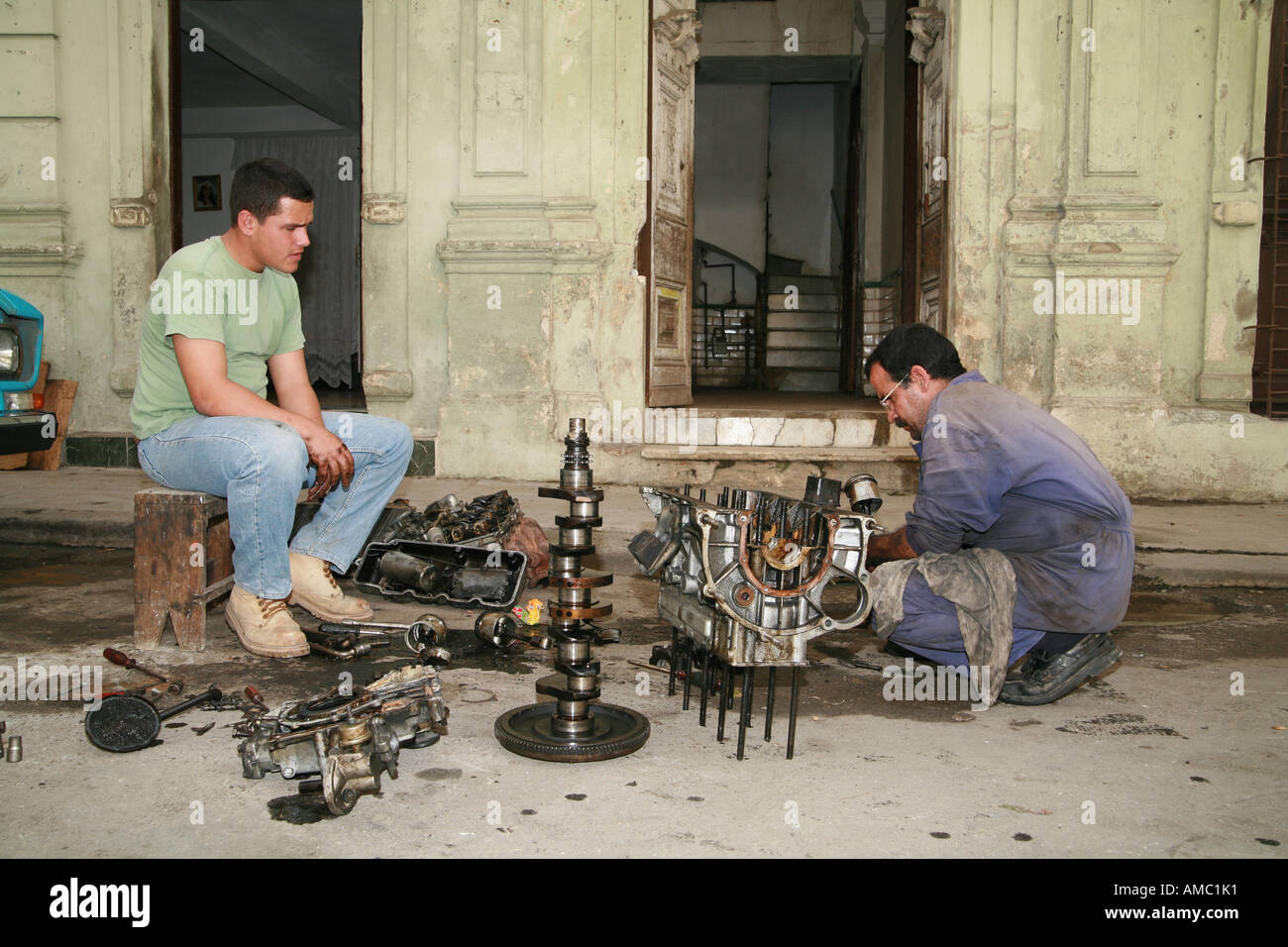 Cuba Havana automechanics in the street working on a motor Stock Photo