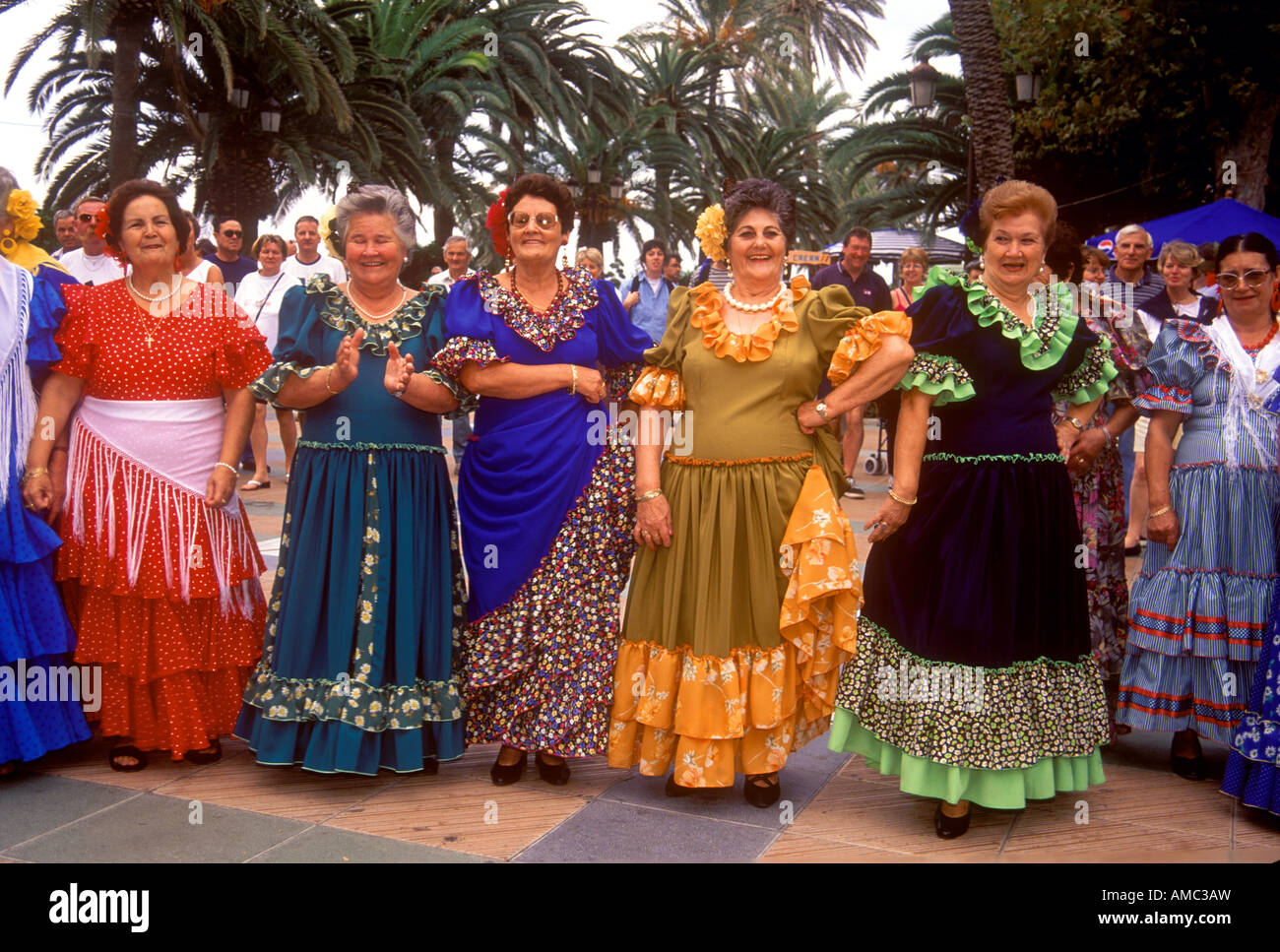 Women in traditional Spanish costume worn at a typical fiesta in the