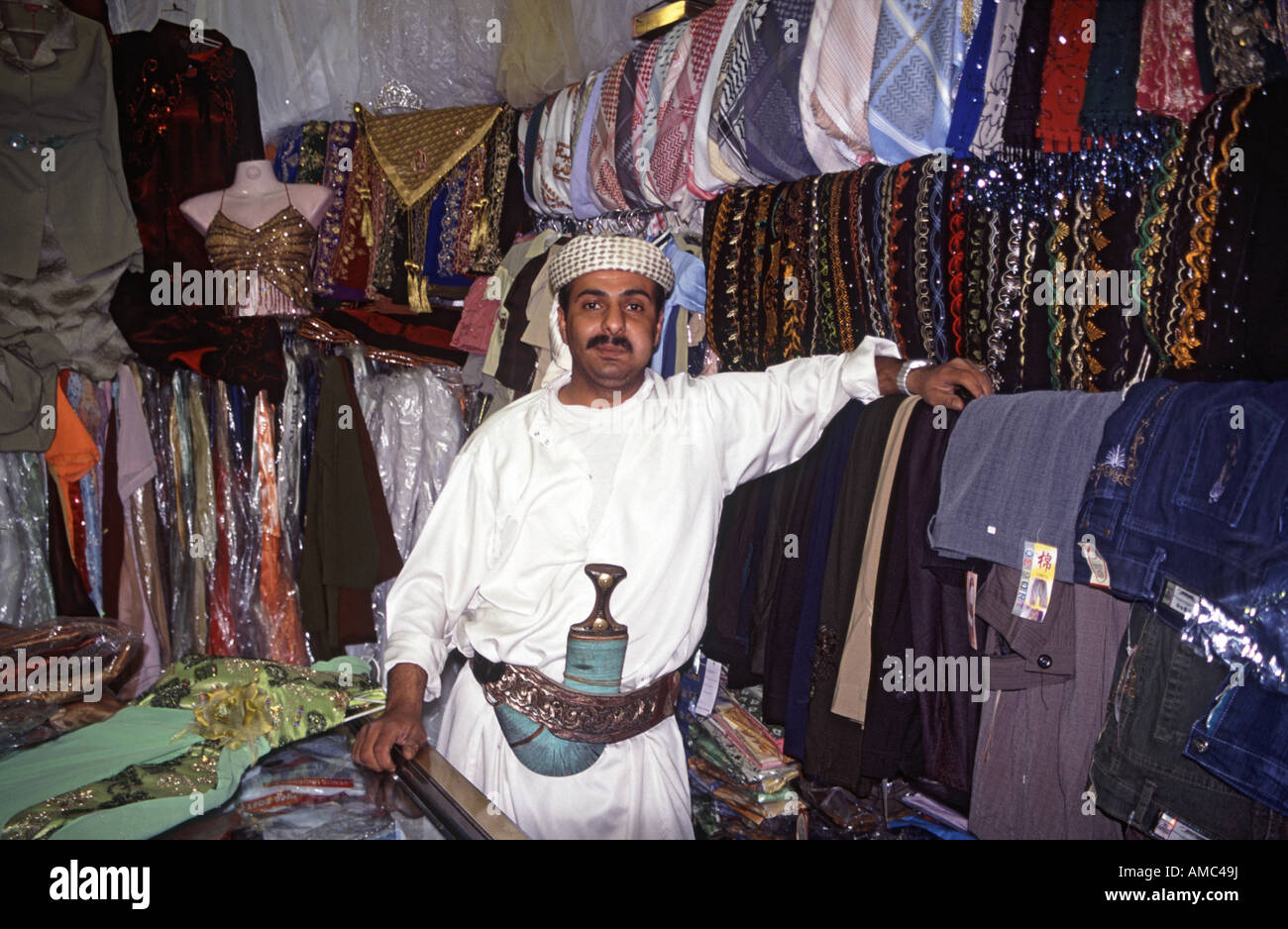 Yemeni fabric seller chewing qat in his shop in Sana'a market Yemen Stock Photo