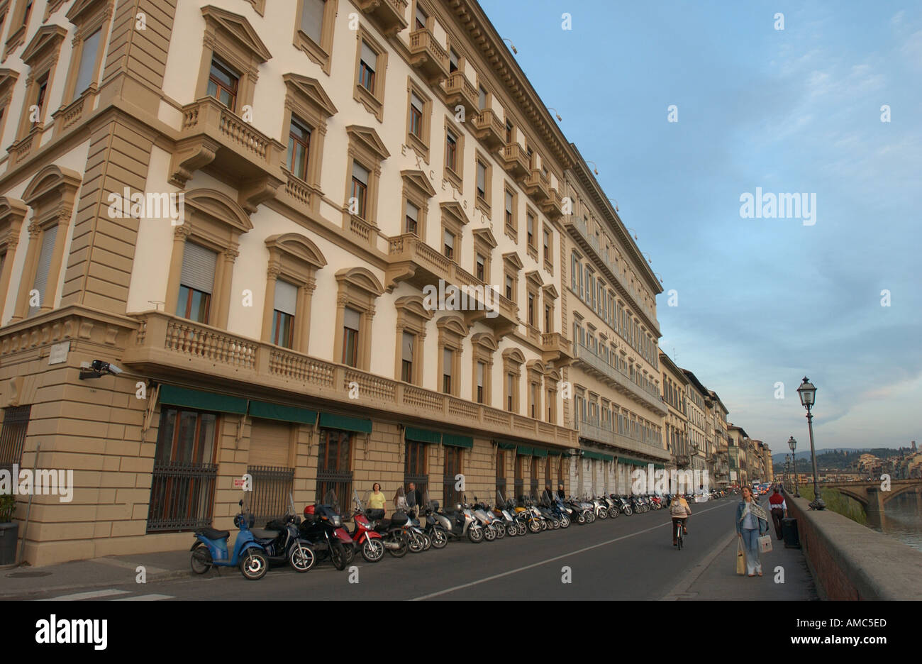 Street of Florence Italy Arno River cloud clouds cyclist balconies bridges bike bicycles building arch arches architecture Stock Photo