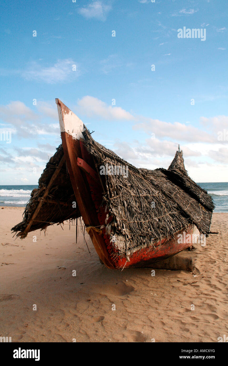 Traditional fishing boat, called a vallom on a beach in Kerala Stock Photo