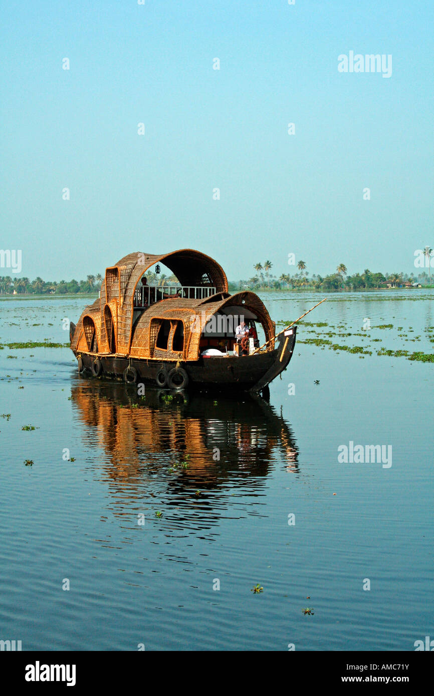 A houseboat cruises the backwaters of Kerala Stock Photo