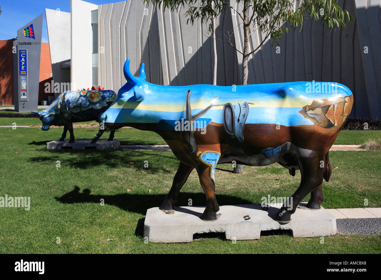 Interactive public art exhibition of painted fibreglass cows in front