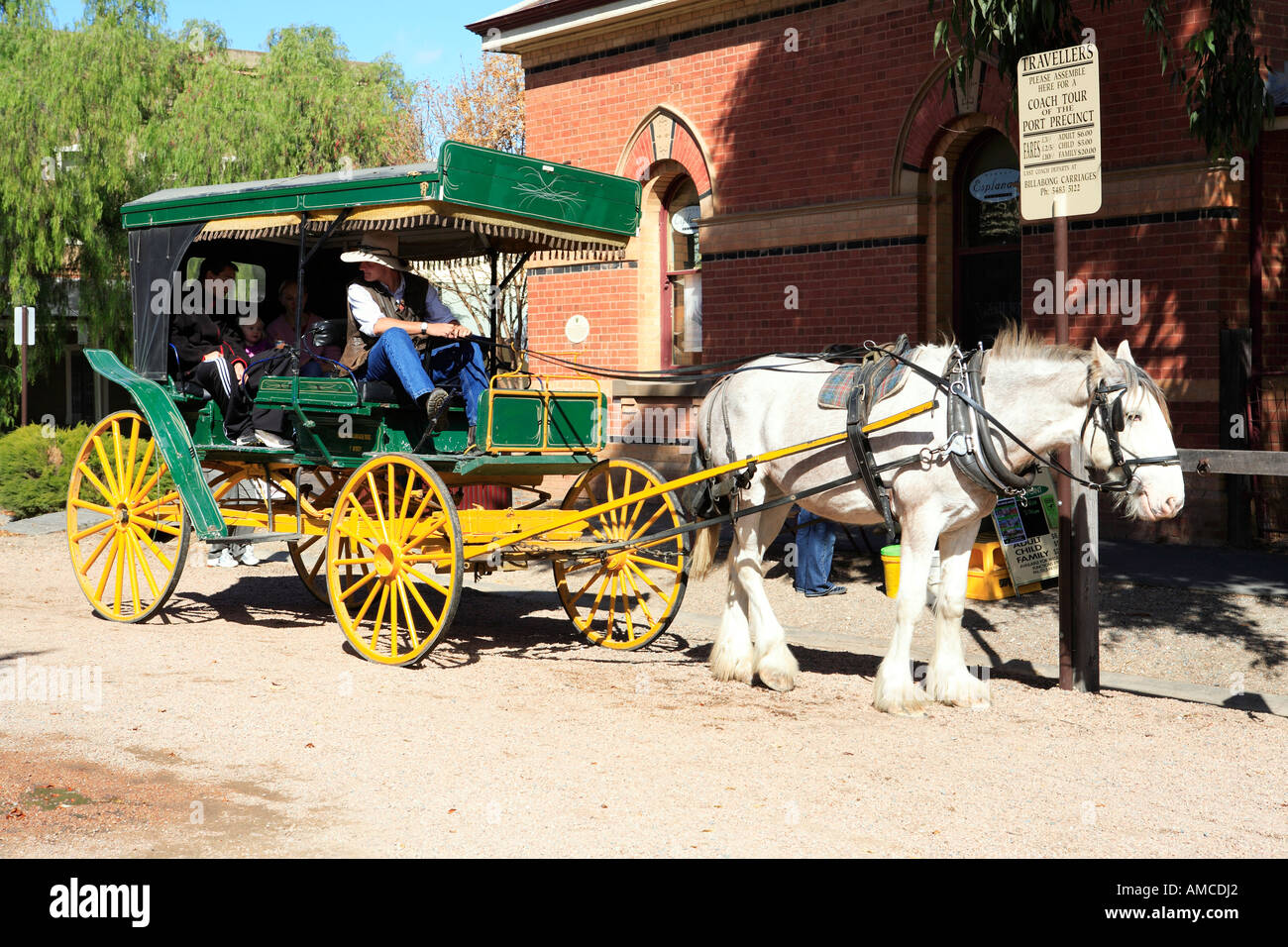 Green and yellow carriage and draught horse on Murray Esplanade, Echuca, Victoria, Australia Stock Photo