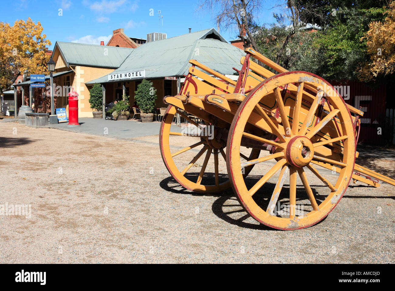 Orange wooden dray on Murray Esplanade, historic precinct, Echuca, Victoria, Australia Stock Photo