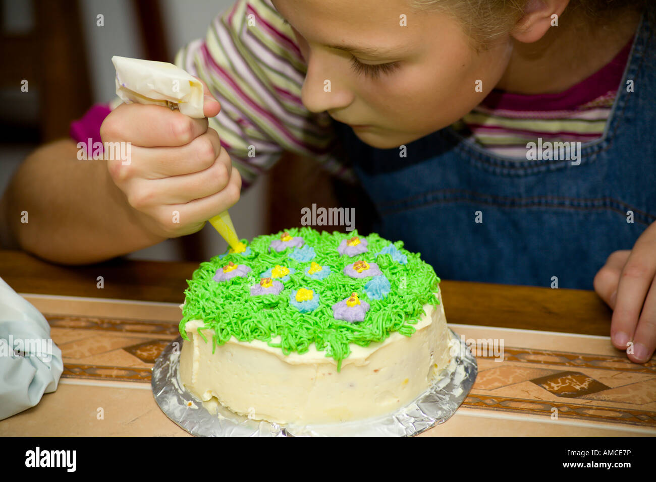 Young girl learning to decorate cakes Stock Photo Alamy