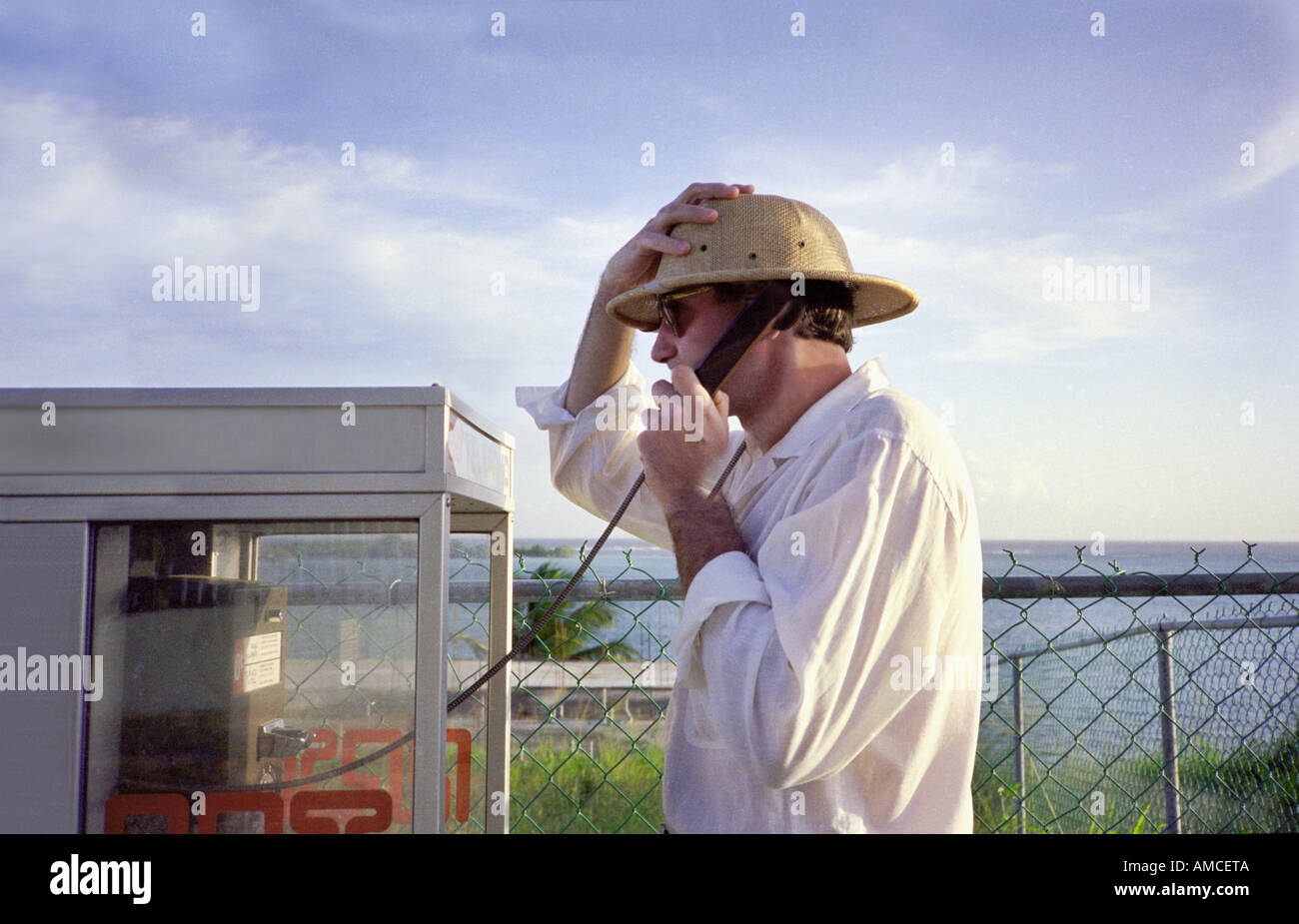 man at phone booth while on vacation Stock Photo