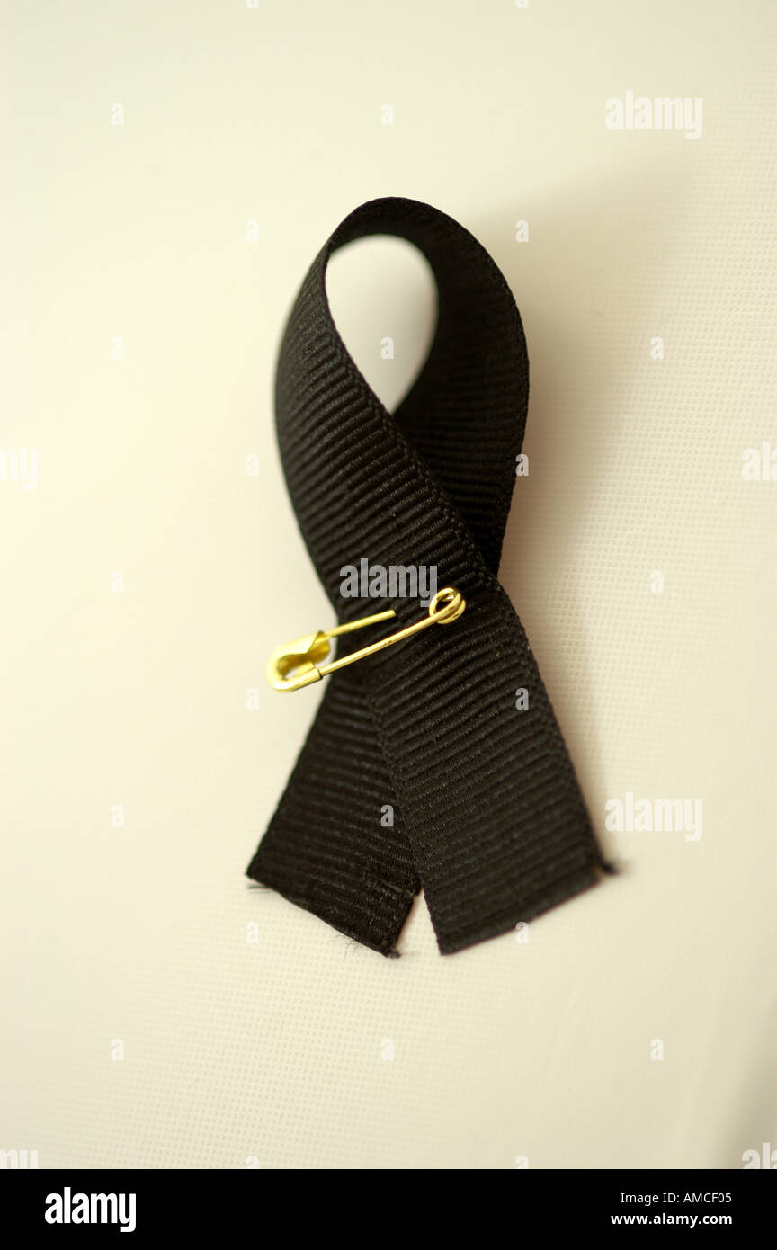 ribbon safety gold pin symbol black vertical Stock Photo - Alamy