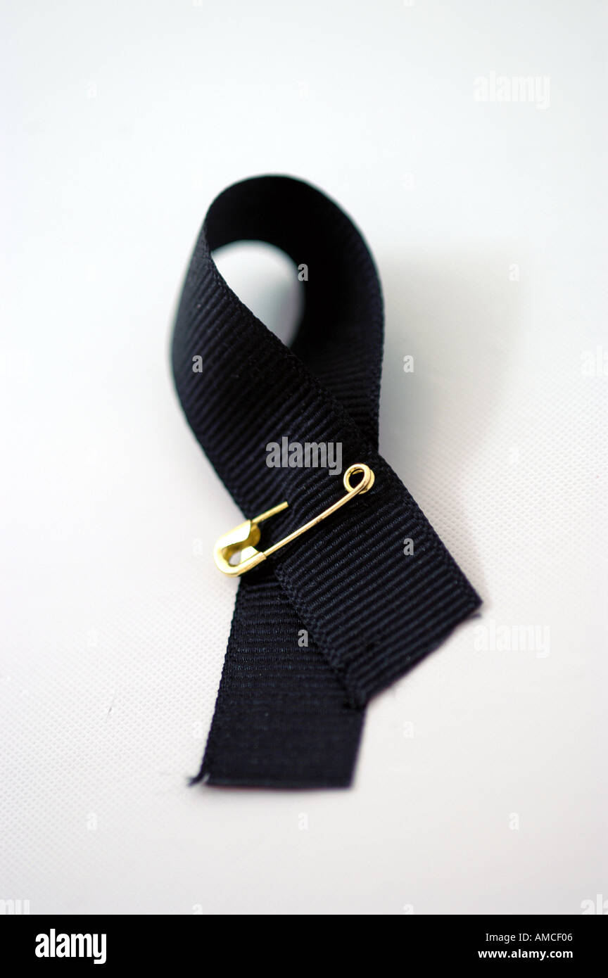 ribbon safety gold pin symbol black vertical Stock Photo - Alamy