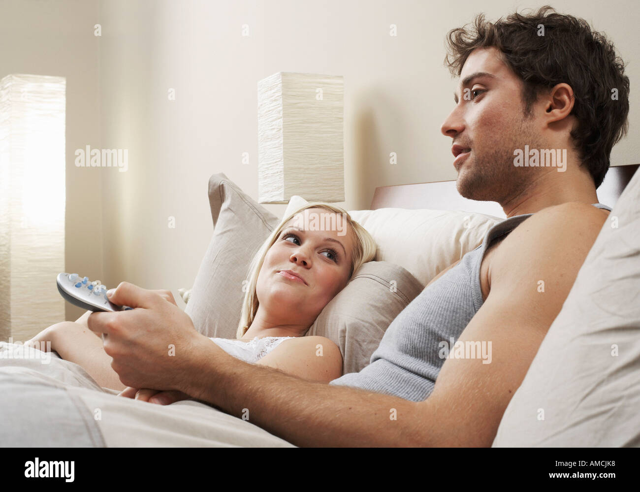 Couple watching tv in bed dark hires stock photography and images Alamy