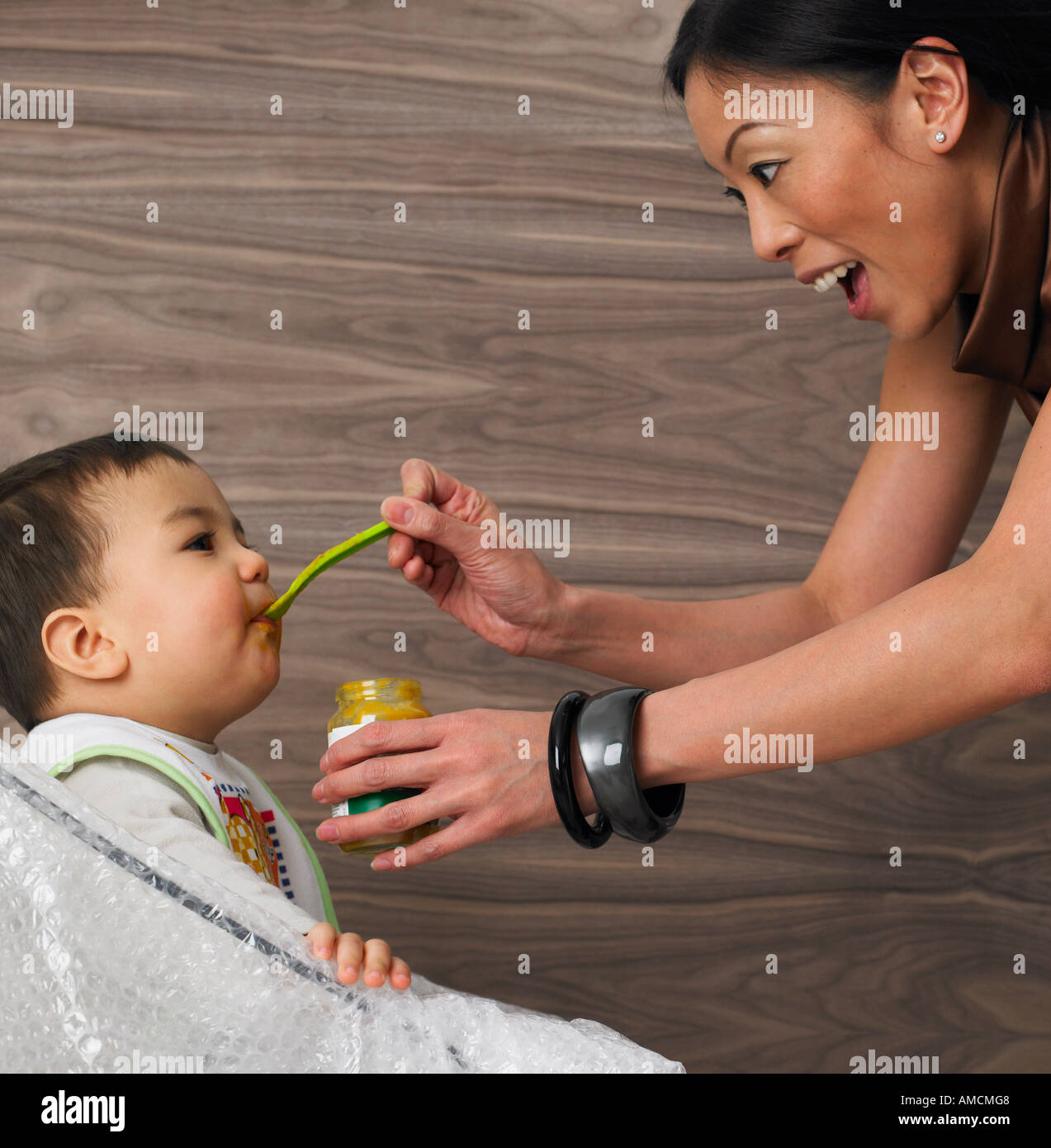 Black mother spoon feeding child hi-res stock photography and images - Alamy