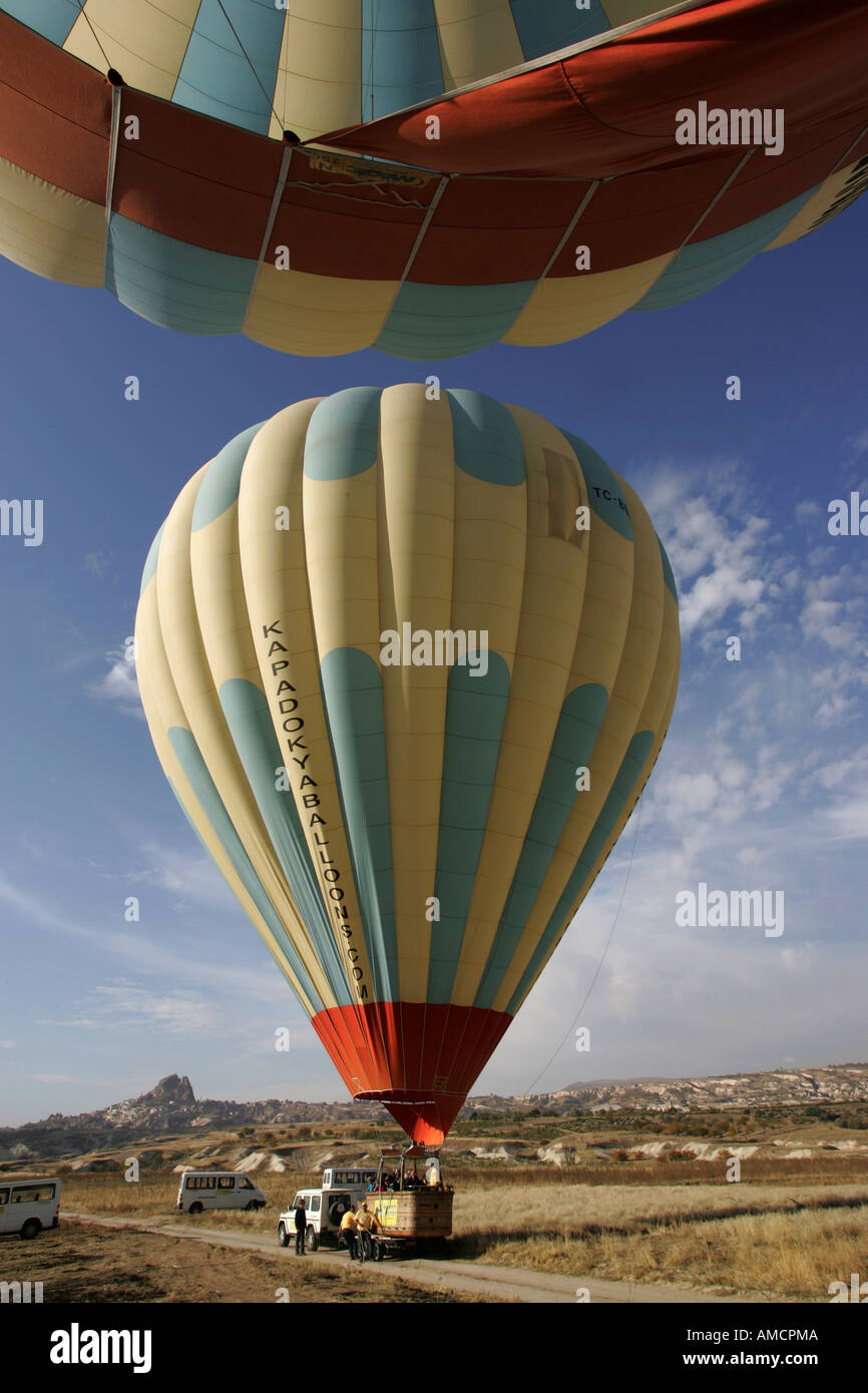 TUR, Turkey, Cappadocia, Hot Air Ballooning over Cappadocia. Balloons of Kapadokya Balloons. Landing Stock Photo