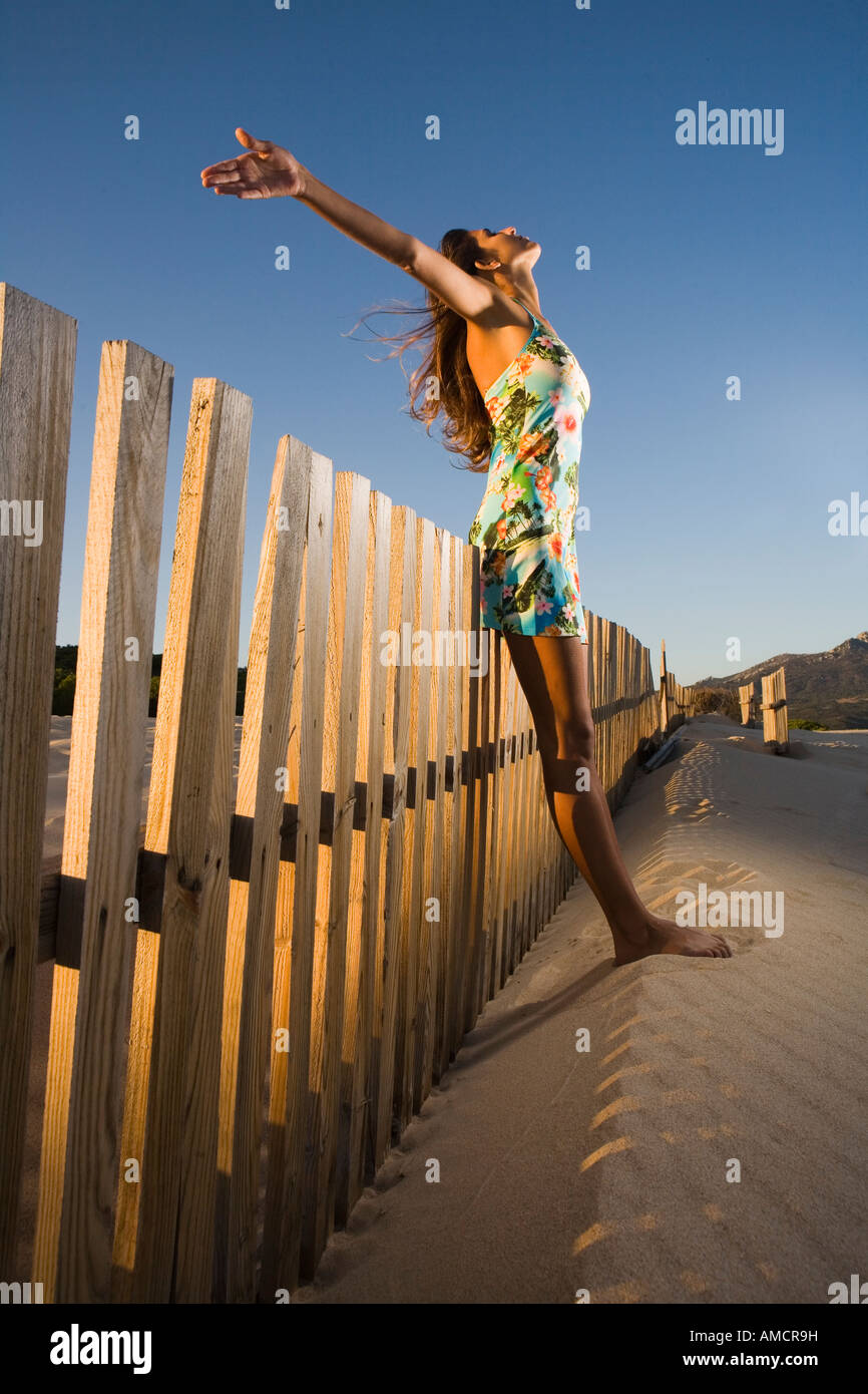 young woman with raised arms enjoying nature Stock Photo