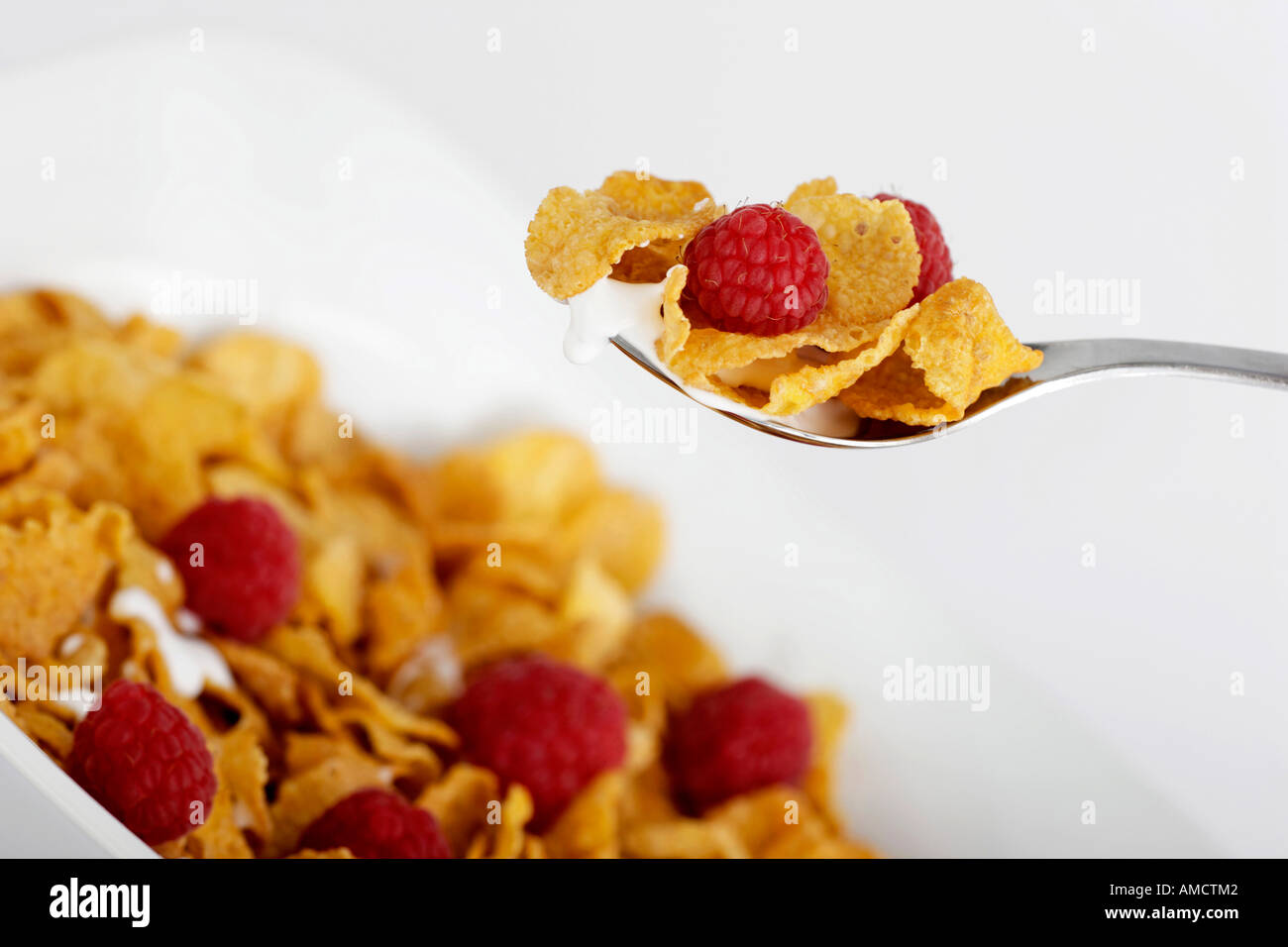 Bowl of cornflakes milk and raspberries Stock Photo