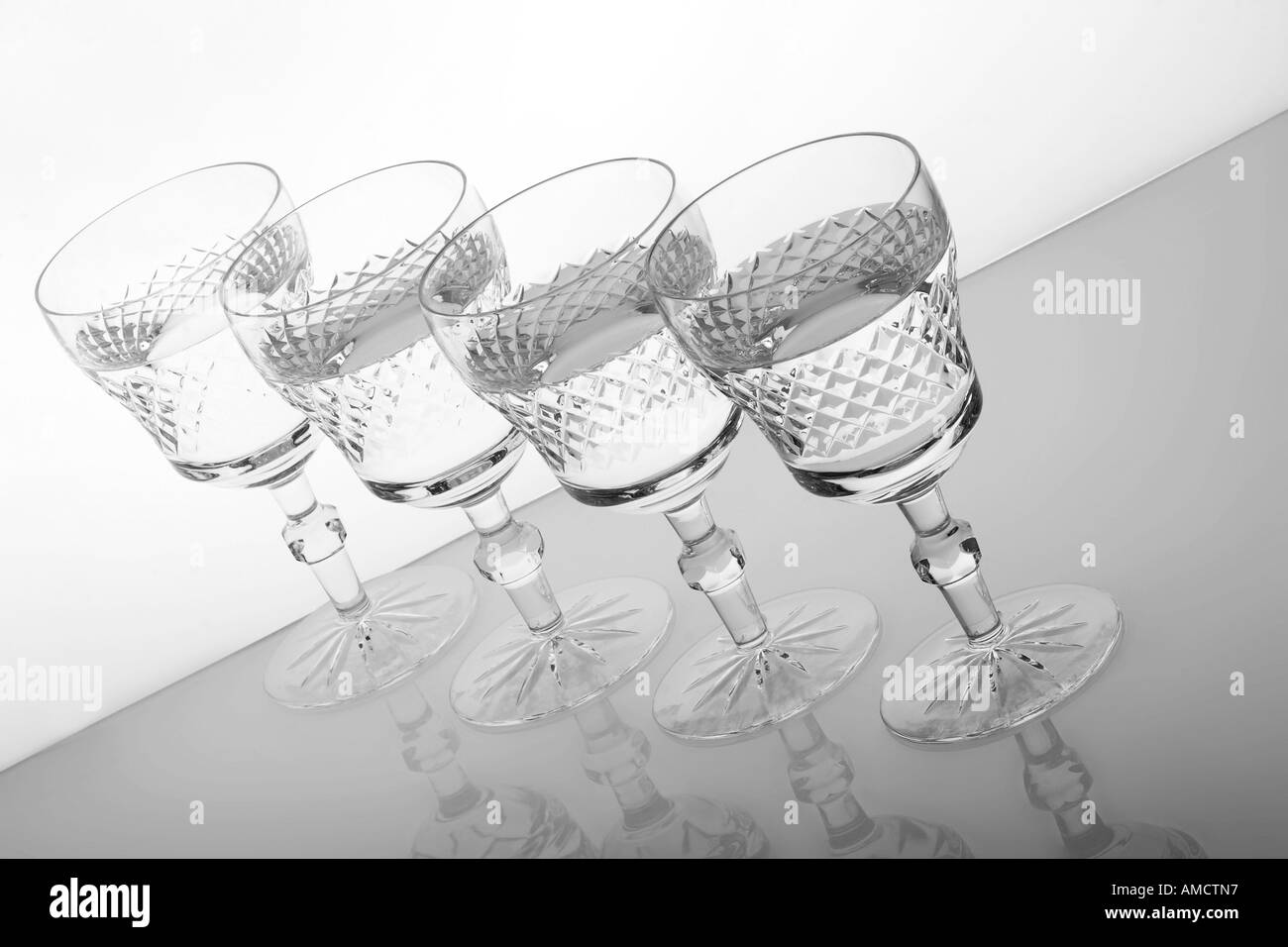 Four glasses in row with water elevated view Stock Photo