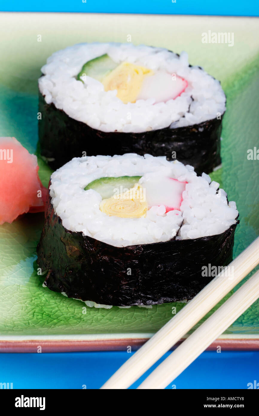 Plate of maki sushi with ginger and chopsticks Stock Photo
