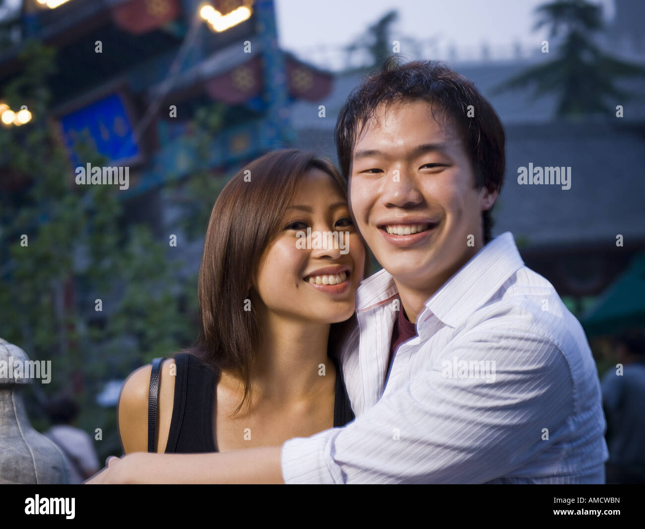 Couple embracing and smiling outdoors Stock Photo