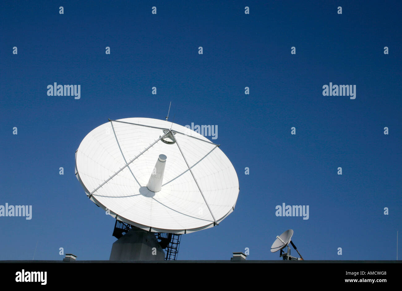 View of satellites and antennas against blue sky Stock Photo