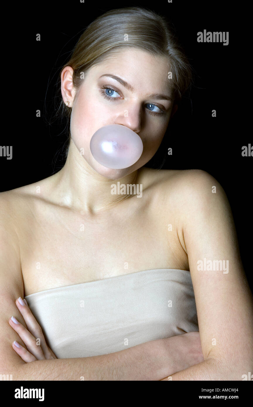 Young woman blowing a chewing gum bubble Stock Photo