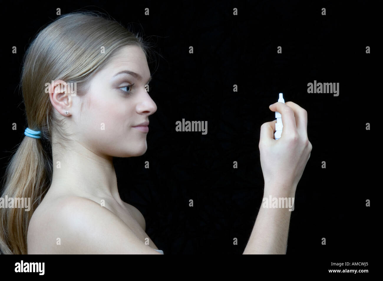 Woman taking nose drop Stock Photo