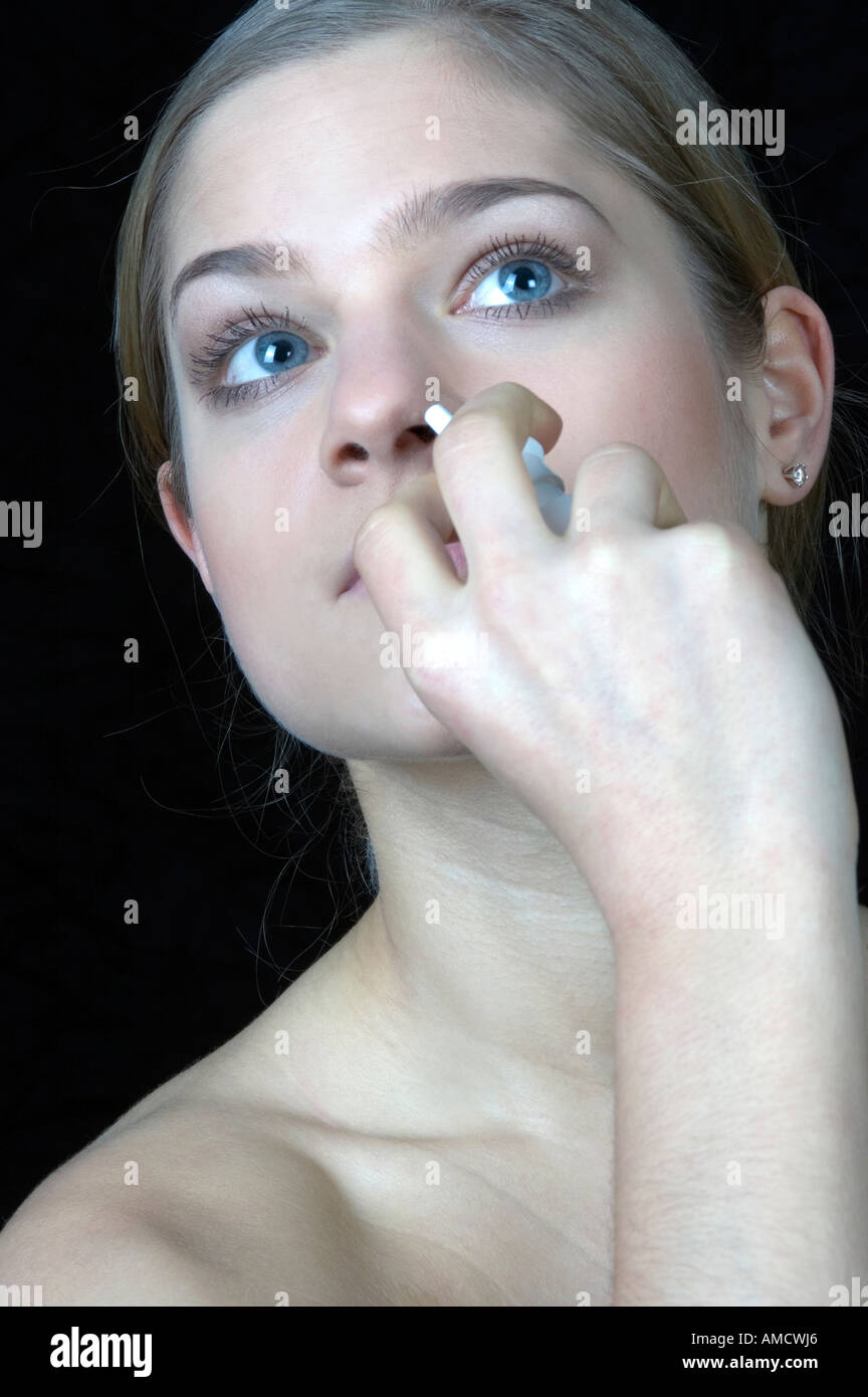 Woman taking nose drop Stock Photo