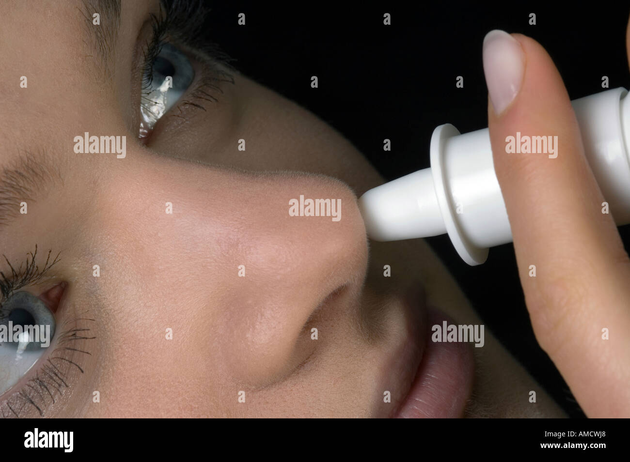 Close up view of woman taking nose drop Stock Photo