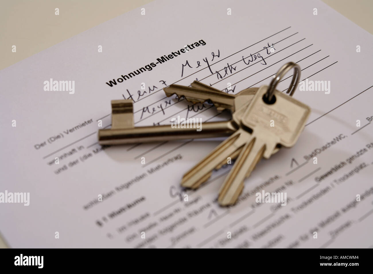 A bunch of keys lying on a german rental contract Stock Photo
