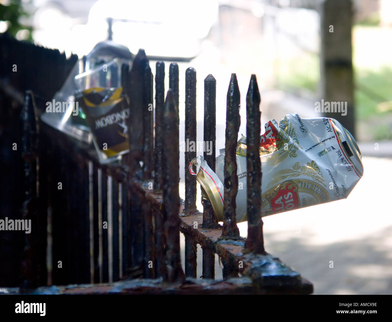 Beer can impaled on railings Stock Photo