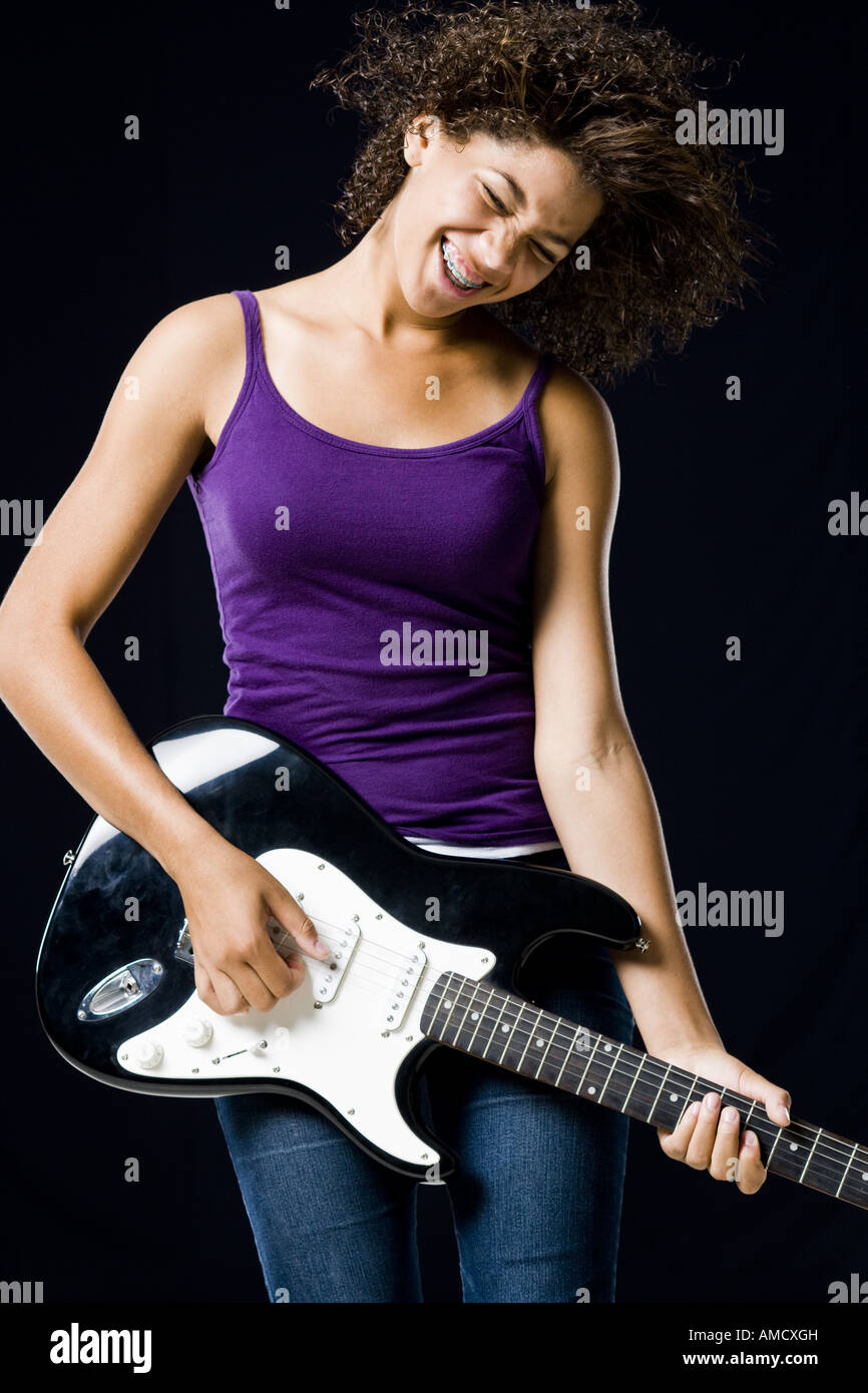 Girl playing electric guitar Stock Photo - Alamy
