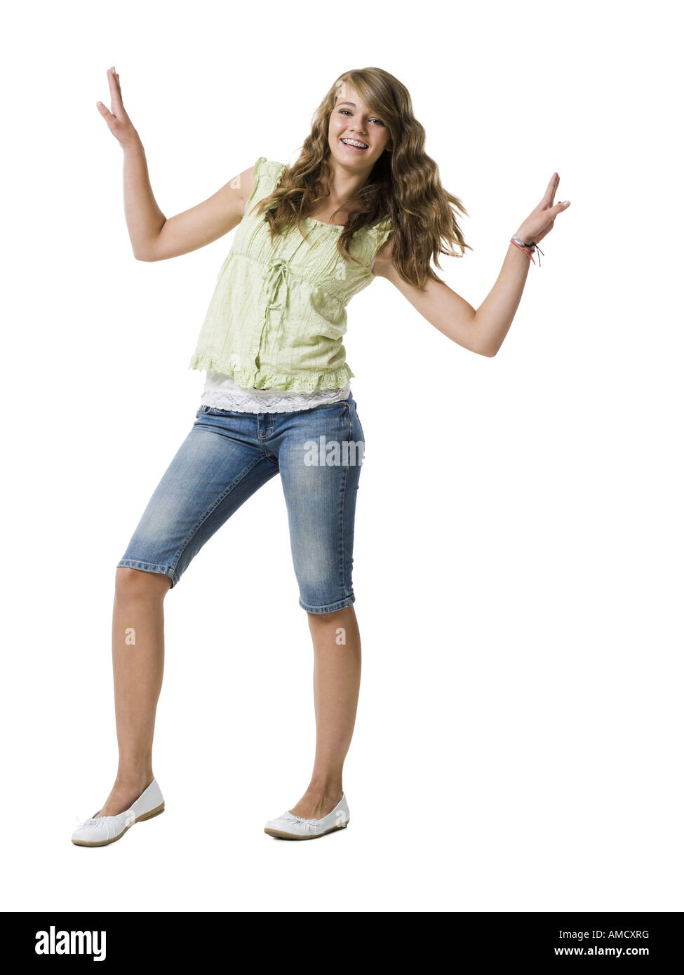 Girl with braces dancing and smiling with arms up Stock Photo Alamy