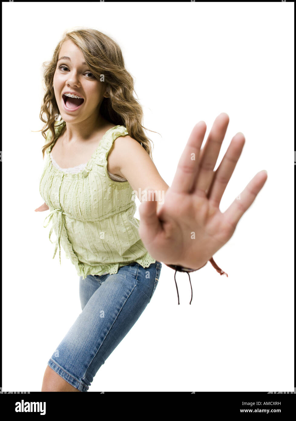 Girl with braces dancing and smiling with arms up Stock Photo Alamy