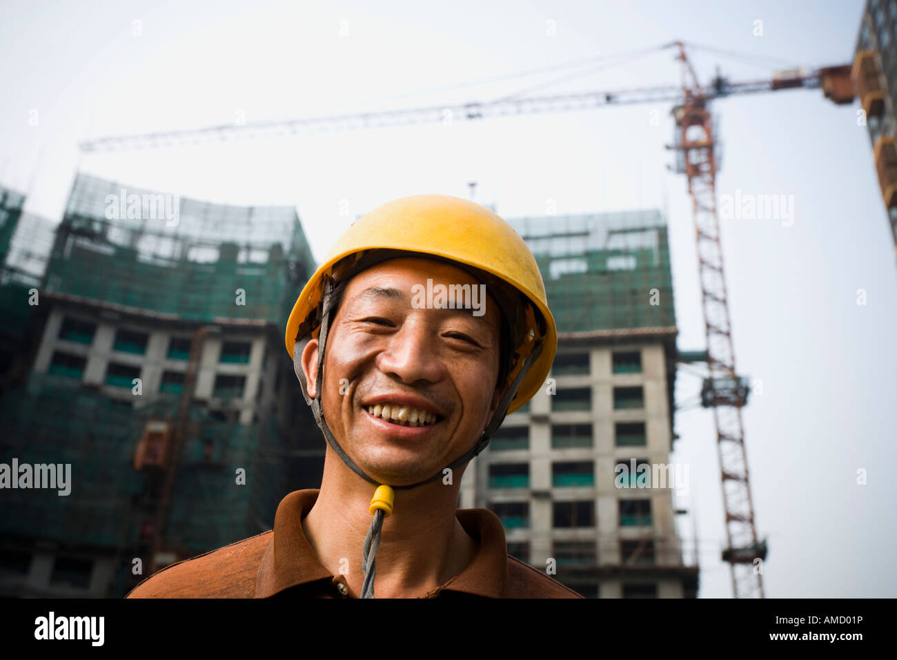 Construction worker outdoors with helmet smiling Stock Photo Alamy