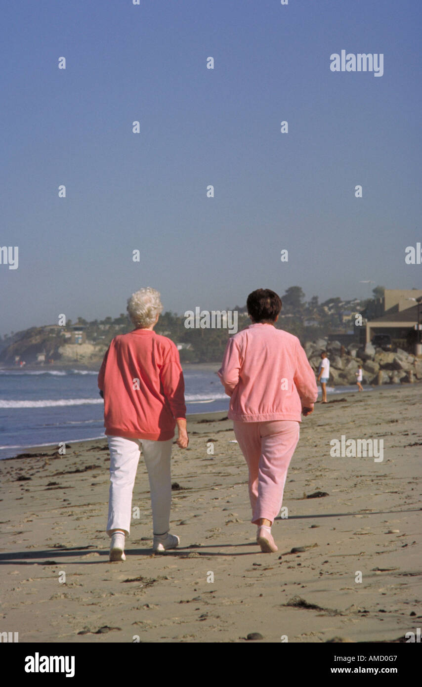 Two women walking the beach Stock Photo - Alamy