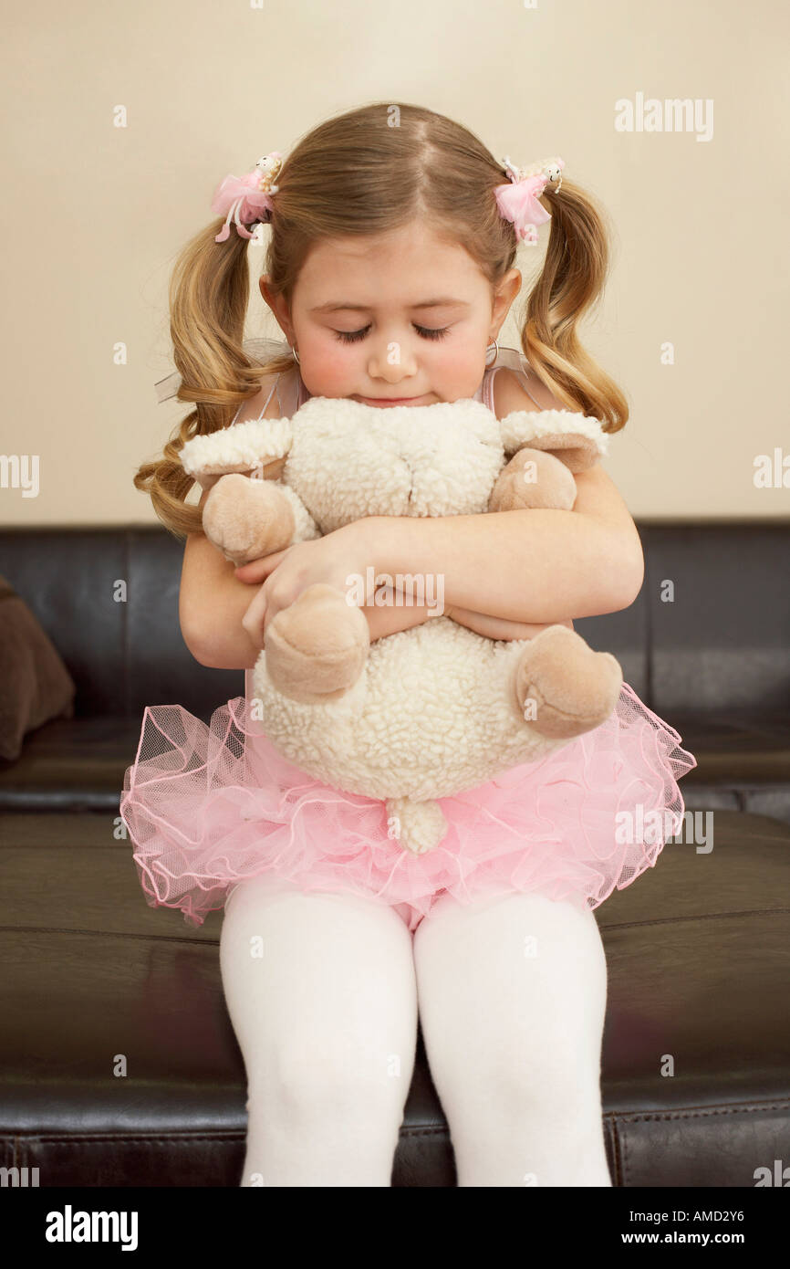 girl hugging stuffed animal