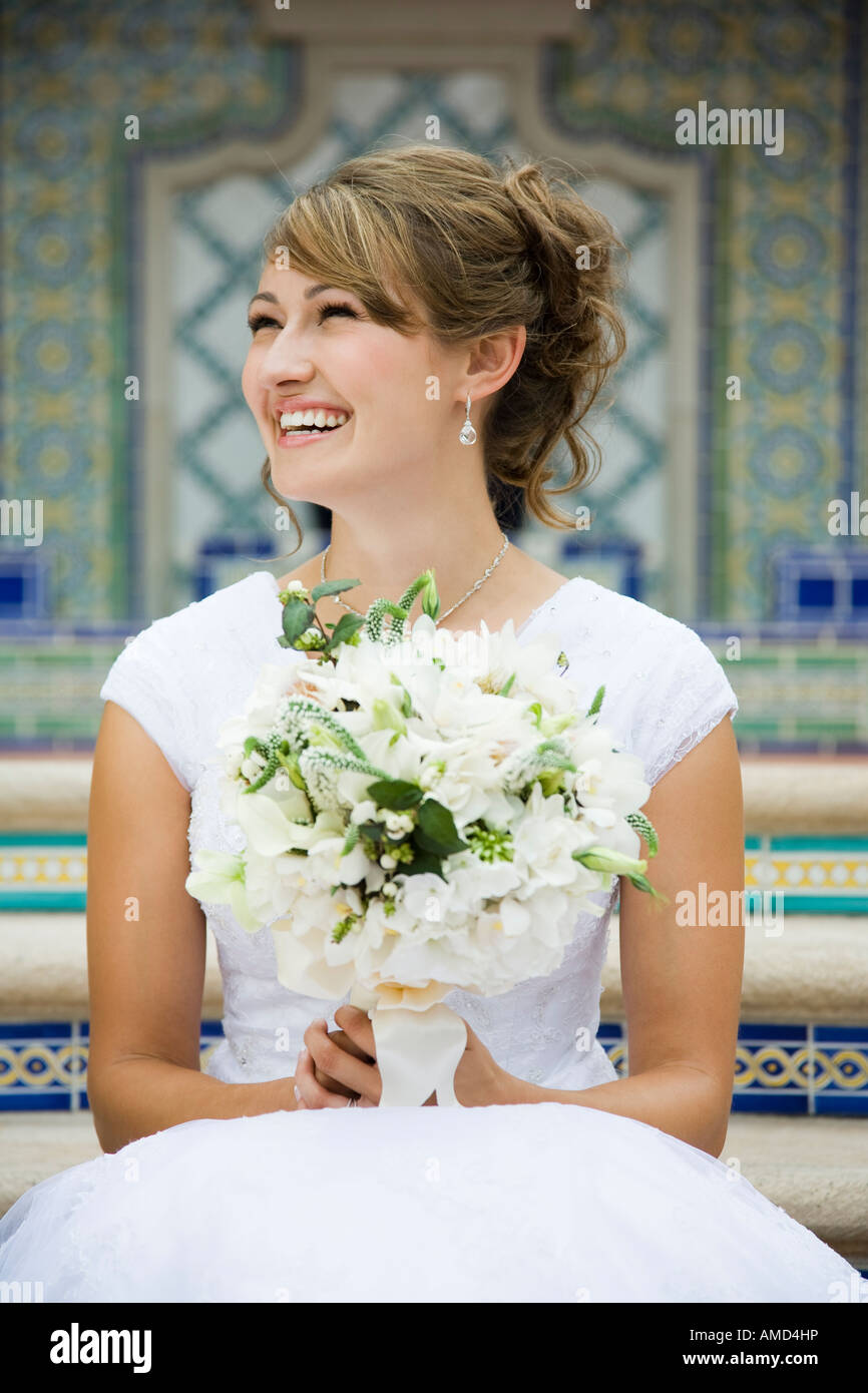 Bride sitting on steps bouquet hi-res stock photography and images - Alamy