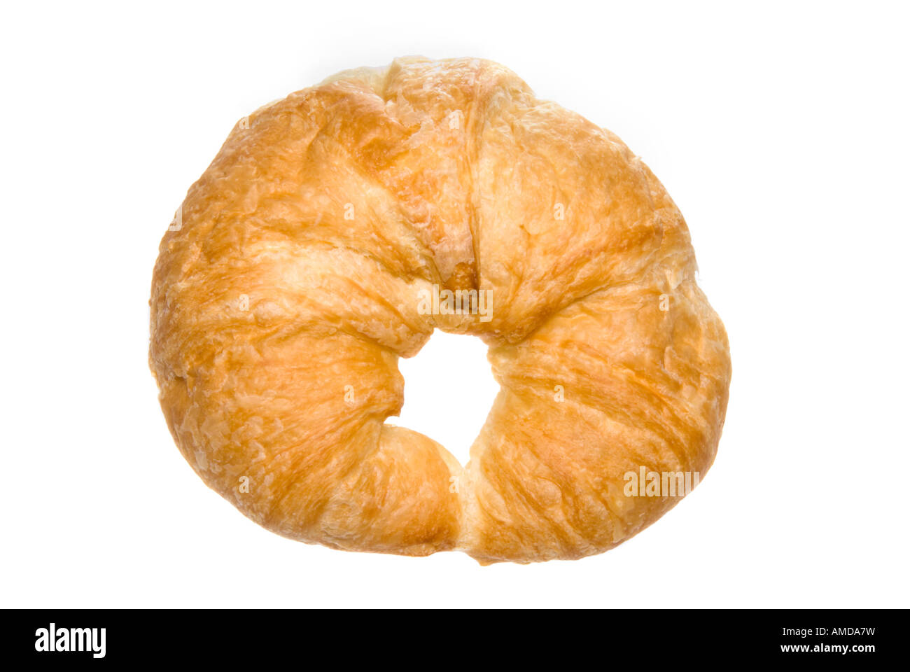 A scrumptious croissant fresh out of the bakery awaits its turn to be consumed Stock Photo