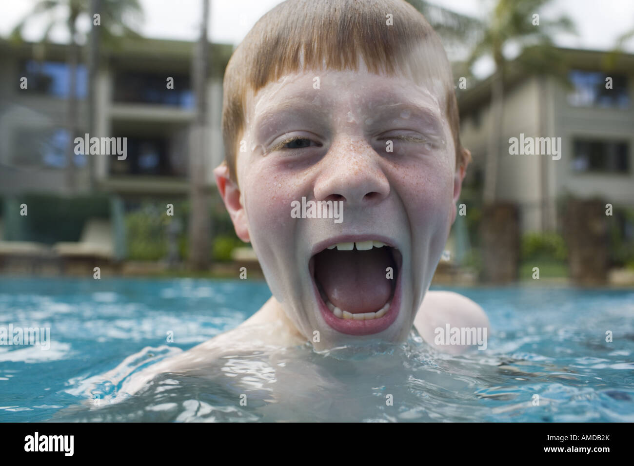Boy in outdoor pool making funny face Stock Photo Alamy