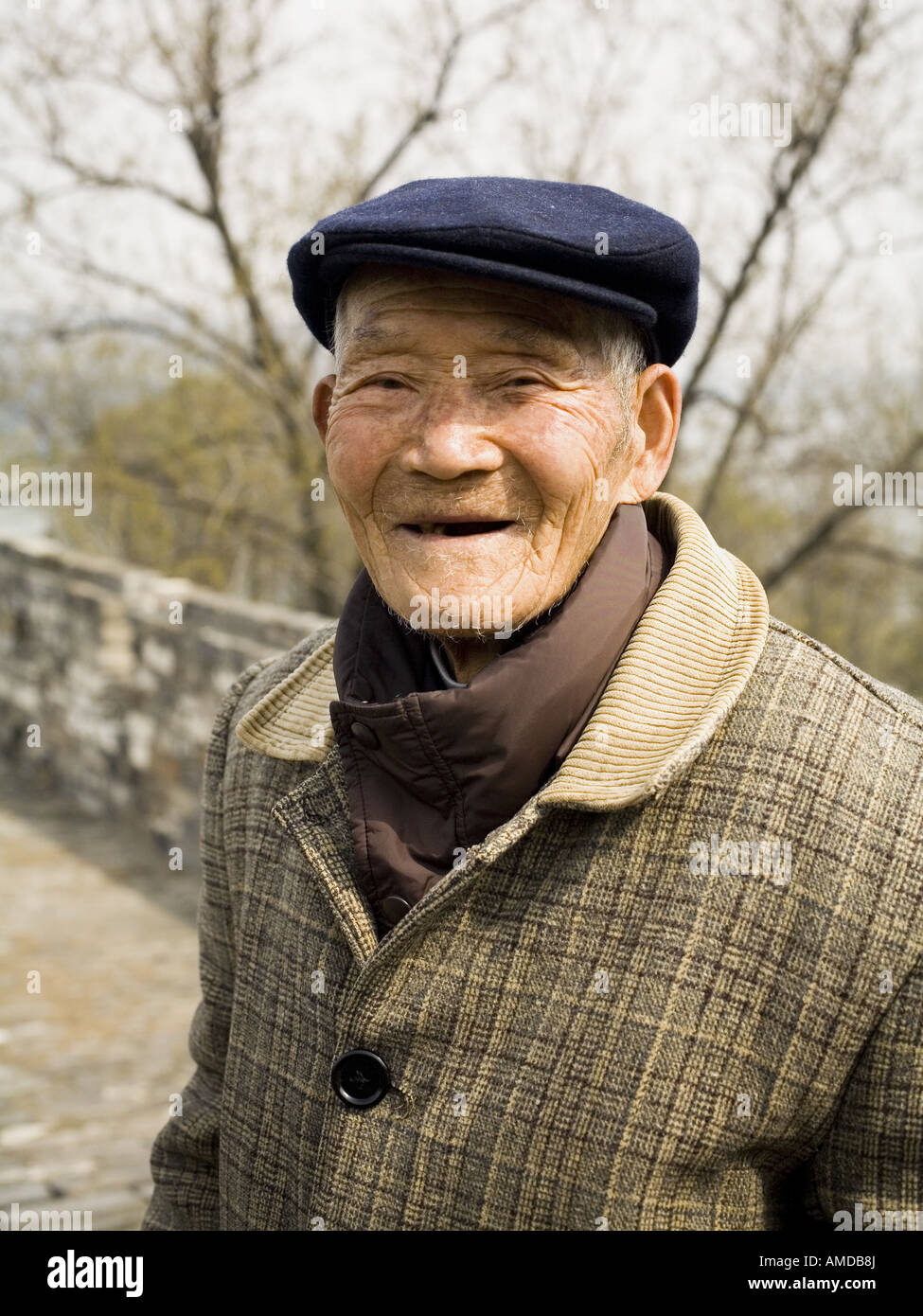 Old man with hat standing outdoors smiling Stock Photo Alamy