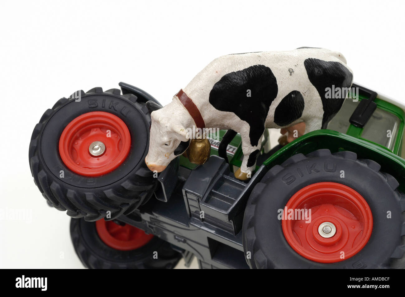 tractor and cow Stock Photo - Alamy