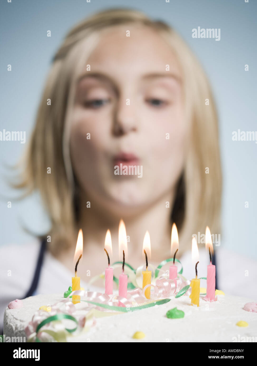 Girl blowing out candles on a birthday cake Stock Photo Alamy