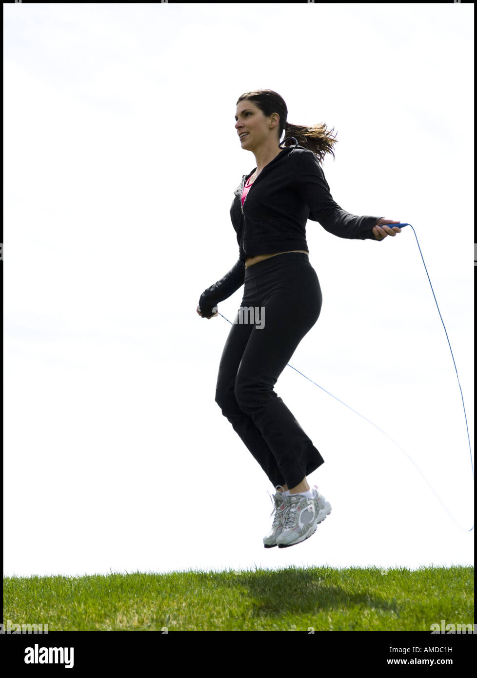 Woman skipping rope outdoors Stock Photo - Alamy