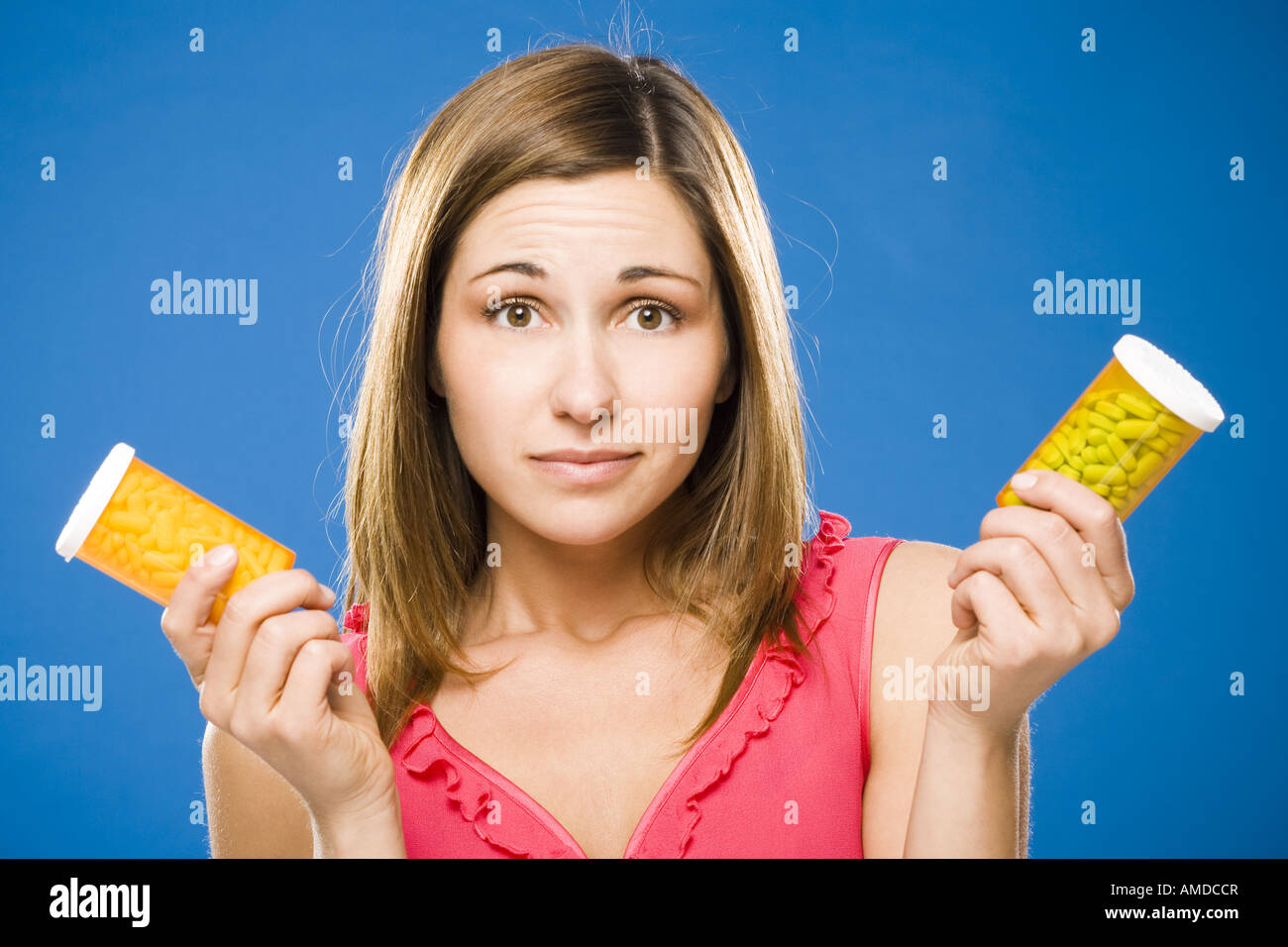 Woman holding two bottles of prescription capsules Stock Photo
