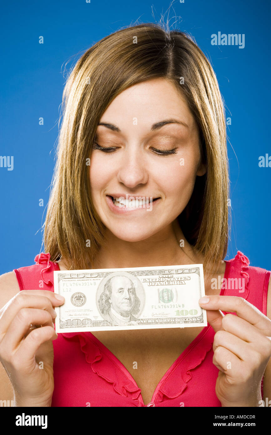 Woman holding American hundred dollar bill Stock Photo