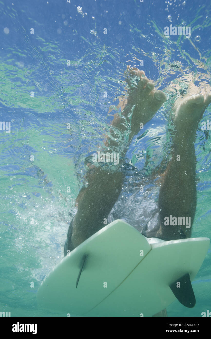 Man underwater with surfboard Stock Photo