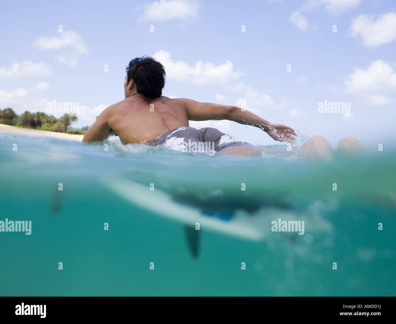 Man lying on surfboard in water Stock Photo Alamy