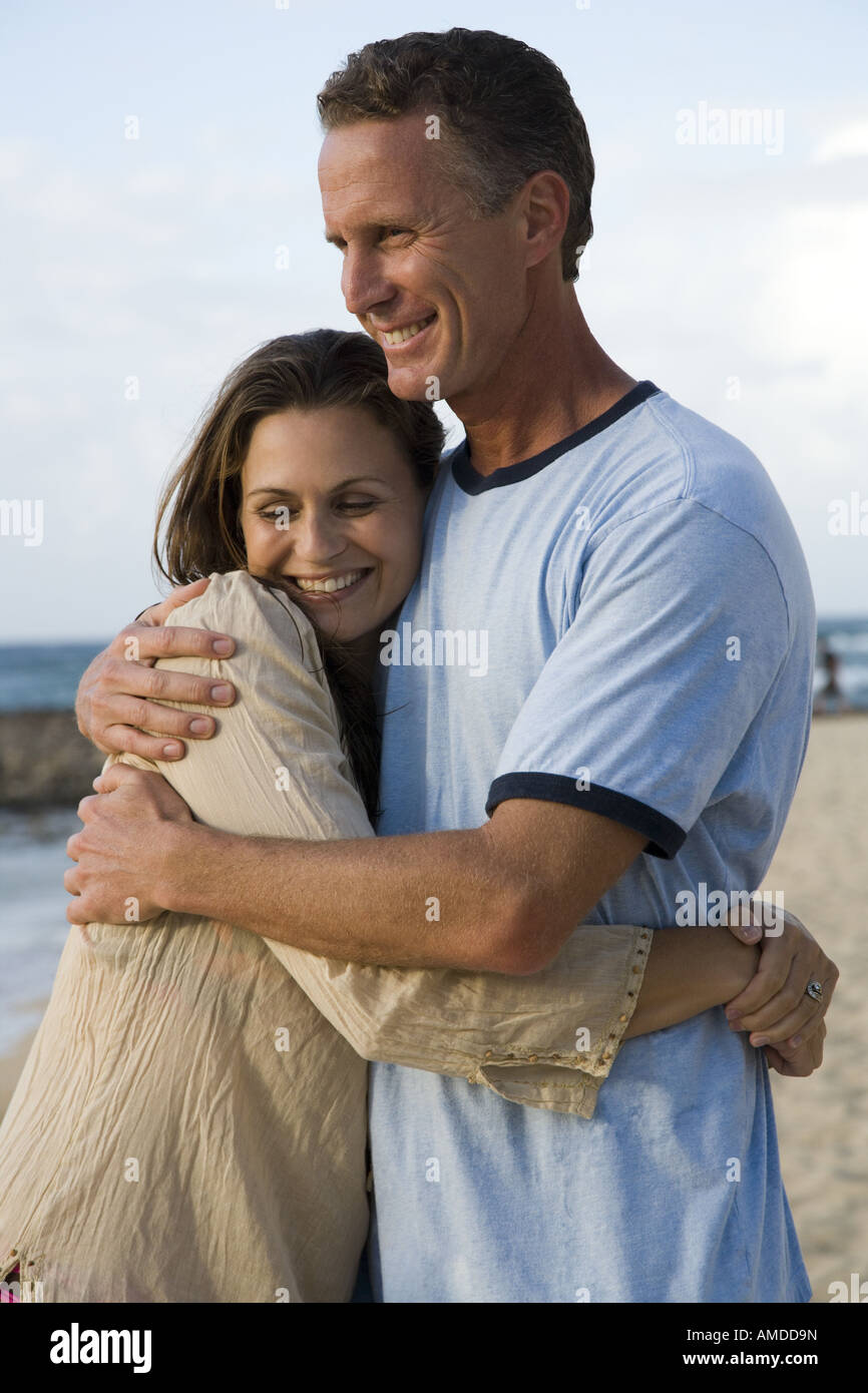 Man and woman hugging on beach Stock Photo - Alamy